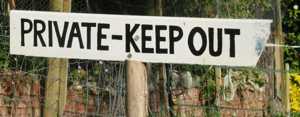 a private keepout sign in a field