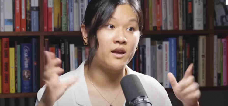 Karen Hao in front of a book shelf